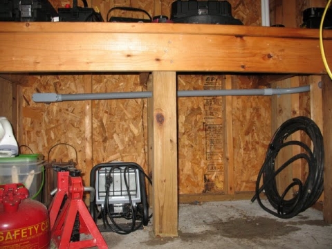 Conduit exits the shed back wall to the outside.